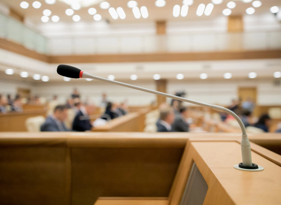 close up of a podium with microphone with background blurred